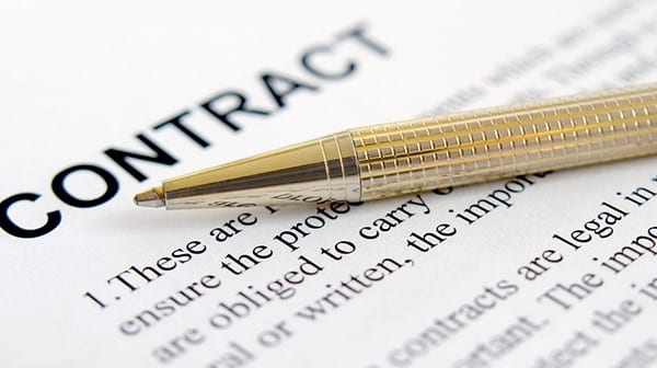 gold pen on contract